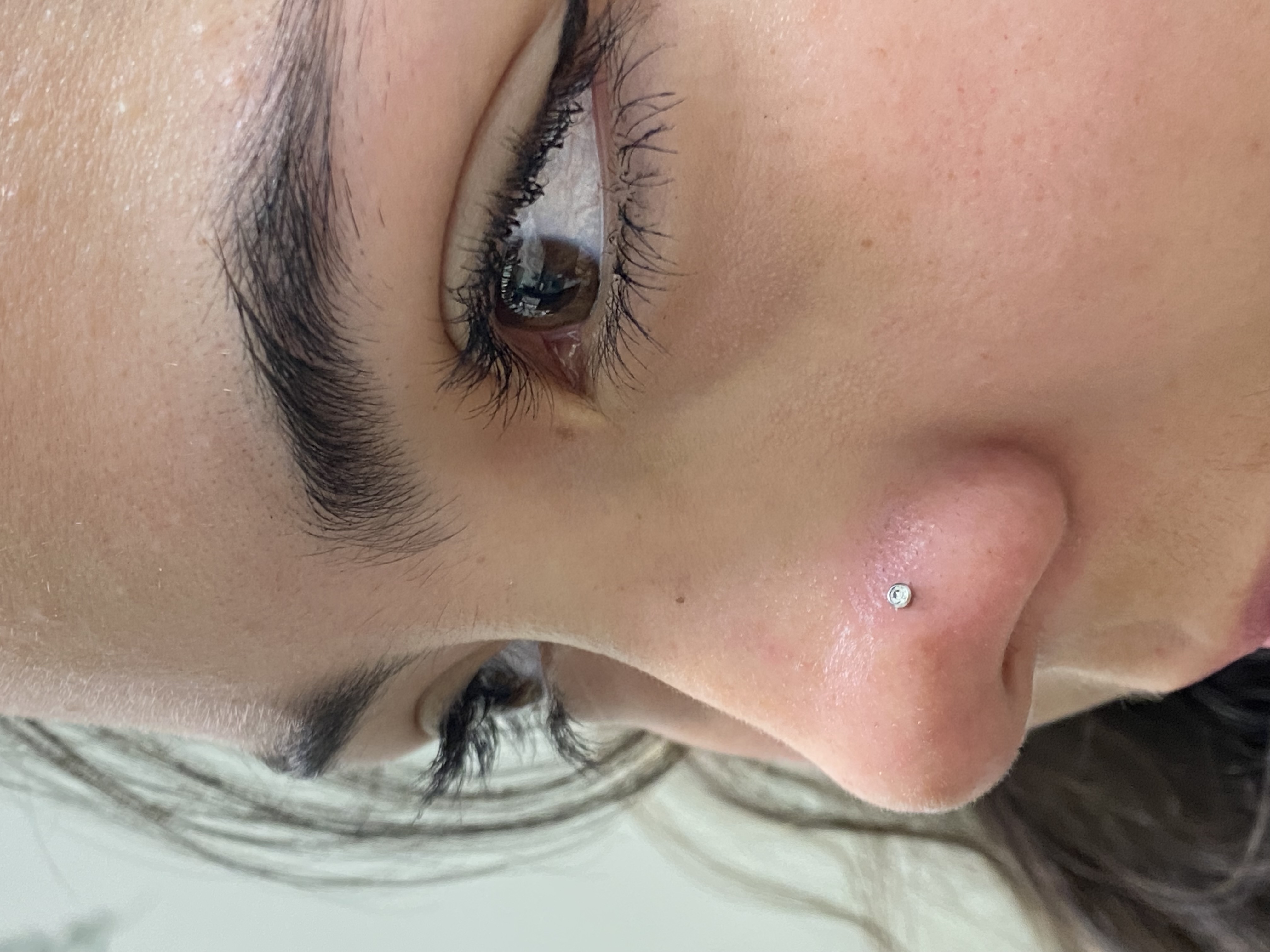 Nose piercing with small gem